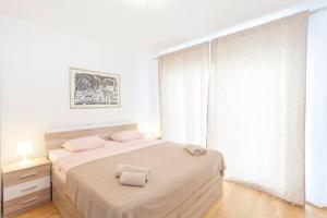Postel nebo postele na pokoji v ubytování Apartments Dora