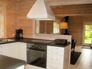 a kitchen with white cabinets and a stove top oven at 6 person holiday home in Skibby in Skibby
