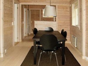 a dining room with a black table and black chairs at 6 person holiday home in Skibby in Skibby