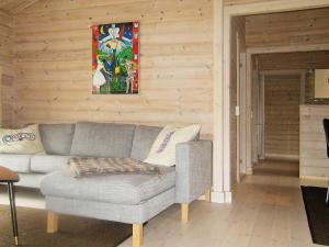 a living room with a couch and a picture on the wall at 6 person holiday home in Skibby in Skibby