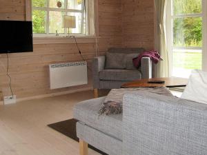 a living room with a couch and a tv at 6 person holiday home in Skibby in Skibby