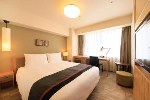 Un pat sau paturi într-o cameră la Richmond Hotel Asakusa