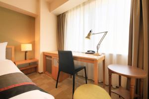 a hotel room with a desk and a bed at Richmond Hotel Asakusa in Tokyo