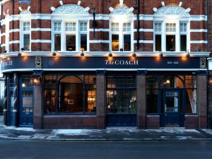 a store front of a building on a street at The Coach in London