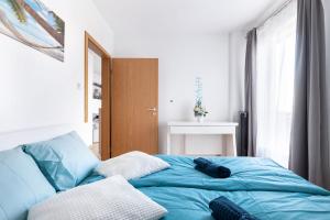 A bed or beds in a room at Matthias Home Midtown Budapest