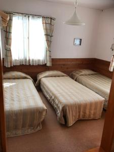 Postel nebo postele na pokoji v ubytování Pension Niimi