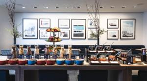 a table filled with different types of food at AMERON Hamburg Hotel Speicherstadt in Hamburg