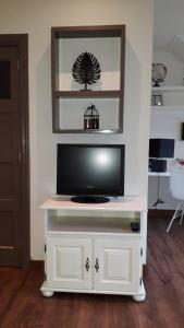 a white entertainment center with a flat screen tv on top at B & B De Gouwe Plek in Hoogwoud