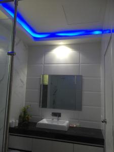 a bathroom with a sink and a blue light at Majestic Residence pool villa Pattaya in Pattaya South