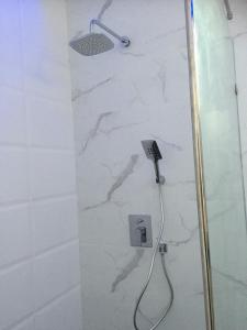 a bathroom with a shower with a white marble wall at Majestic Residence pool villa Pattaya in Pattaya South