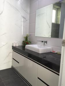 a white bathroom with a sink and a mirror at Majestic Residence pool villa Pattaya in Pattaya South