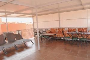 a patio with tables and chairs on a roof at Silia in Marrakesh