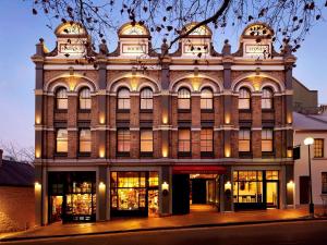 a large building with a clock on the front of it at Harbour Rocks Hotel Sydney – MGallery by Sofitel in Sydney