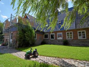 a small toy motorcycle in front of a house at Ferienhof Kragholm in Munkbrarup