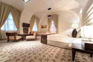 a hotel room with a large bed and a desk at Buda Castle Hotel Budapest in Budapest