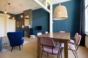 a dining room with a wooden table and chairs at 2 Bedroom 2 Bathroom Canal Apartment in Amsterdam