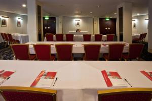 a conference room with a large white table and chairs at Britannia Hotel Coventry in Coventry +44 photos