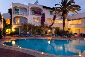 a hotel with a swimming pool in front of a building at Hotel Continental Ischia in Ischia