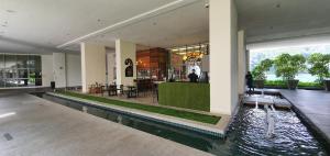a lobby with a pool in the middle of a building at Amazing KLCC View @ Regalia Residence in Kuala Lumpur