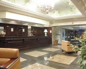 a large lobby with a chandelier and a waiting room at Britannia Hotel Coventry in Coventry