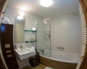 a bathroom with a tub and a sink and a shower at B&B Ferme Château de Laneffe in Laneffe