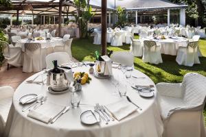 a table set up for a wedding with white tables and chairs at Hotel Continental Ischia in Ischia