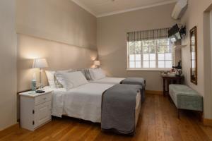 a bedroom with a large white bed and a window at In Abundance Guest House in Montagu +49 photos