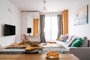 a living room with a couch and a tv at ArtApart Stare Miasto Wrocław in Wrocław