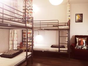 two bunk beds in a room with a couch at PIJAMA HOUSE in Plovdiv