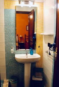 a bathroom with a sink and a mirror at A Casa Di Mamma in Milazzo