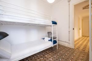 a room with two bunk beds and a hallway at b42 - MODERNIST APARTMENT FOR LARGE GROUPS IN EIXAMPLE in Barcelona