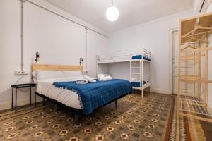 a bedroom with a bed and a bunk bed at b42 - MODERNIST APARTMENT FOR LARGE GROUPS IN EIXAMPLE in Barcelona