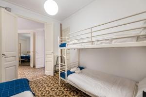 a bedroom with two bunk beds and a hallway at b42 - MODERNIST APARTMENT FOR LARGE GROUPS IN EIXAMPLE in Barcelona