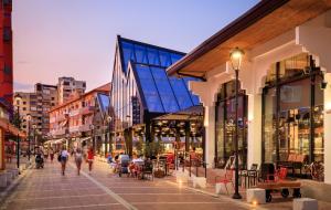 a group of people walking down a street with buildings at Tirana City Center Apartment in Tirana