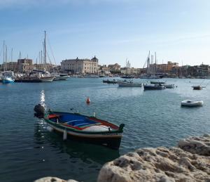 a small boat sitting in the water in a harbor at Lakkios charming suites and rooms in Syracuse