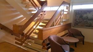 a staircase in a house with two chairs and a table at Coventry Hill Hotel in Coventry +32 photos