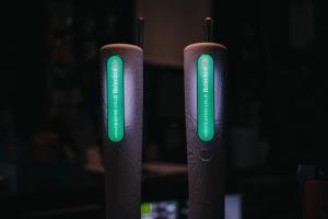 two remote controls in a dark room with green lights at The Saddle Inn in Chester