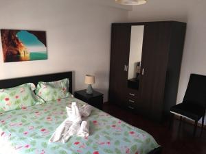 a bedroom with a bed with a stuffed animal on it at CASA JUDITE in Faro