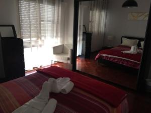 a hotel room with a bed and a mirror at CASA JUDITE in Faro