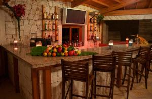 a bar with a bunch of fruit on a counter at Lycia Hotel in Kaş
