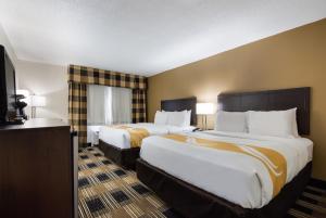 a hotel room with two beds and a television at Quality Inn Oneonta Cooperstown Area in Oneonta +36 photos