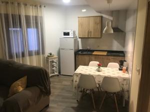 a kitchen with a table and chairs in a room at LA GARGANTILLA in Jerte