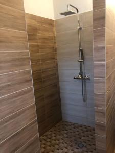 a shower with a tile floor and a shower head at Penzion Imrvere Žamberk in Žamberk