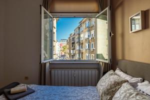 a bedroom with a bed and a large window at Apartment 11 in Sofia