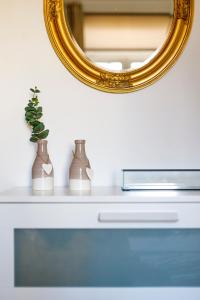 a mirror sitting on top of a table with a vase at Apartment 11 in Sofia
