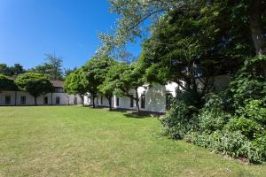 an empty yard in front of a building with trees at Europa Gatwick Hotel in Crawley
