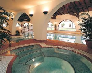 a large swimming pool in a building with a pool at Europa Gatwick Hotel & Spa in Crawley