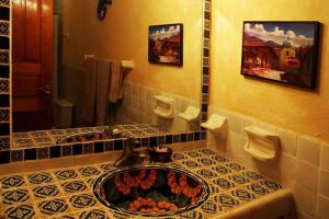 a bathroom with a sink with flowers in it at Beautiful 1 Bedroom apt @ San Miguel Allende (R1) in San Miguel de Allende