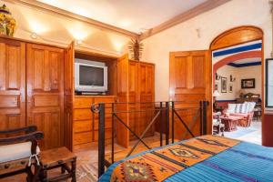 a bedroom with a bed and a flat screen tv at Beautiful 1 Bedroom apt @ San Miguel Allende (R1) in San Miguel de Allende