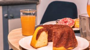 a table with a plate of bread and a glass of orange juice at Lux apartment downtown in Serres